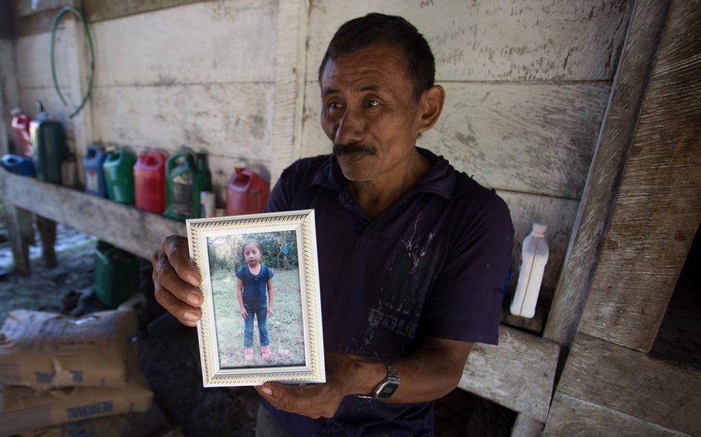 El abuelo de Jakelin Caal, Domingo, sostiene una foto de Jakelin en su casa después de que la familia se enteró de su muerte. Fotografía de Jeff Abbott