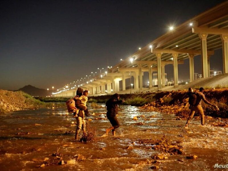 Migrantes cruzan el Río Bravo para entregarse a los agentes de la Patrulla Fronteriza y solicitar asilo en El Paso, Texas. Visto desde Ciudad Juárez.