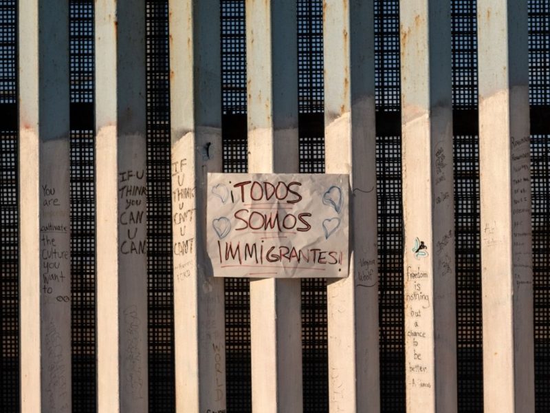 En la foto de archivo se ve un letrero en la frontera entre Estados Unidos y México que dice en español "todos somos migrantes", en Playas de Tijuana, noroeste de México.